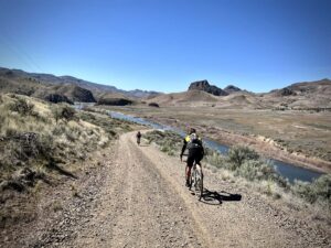 Gravel cyclists and John Day River in background.