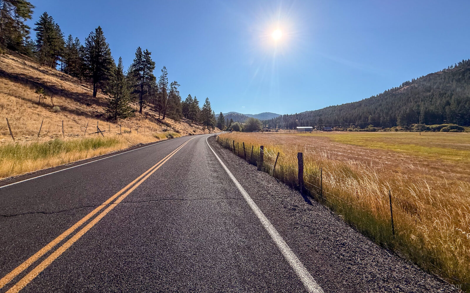 Paved road through farm lands.