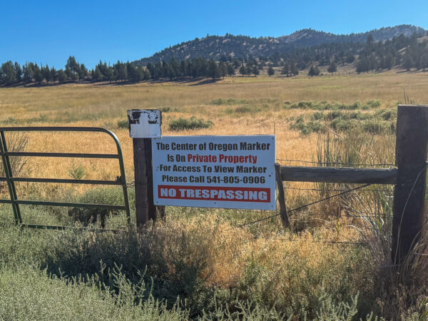 Sign to the post marker in the ground.
