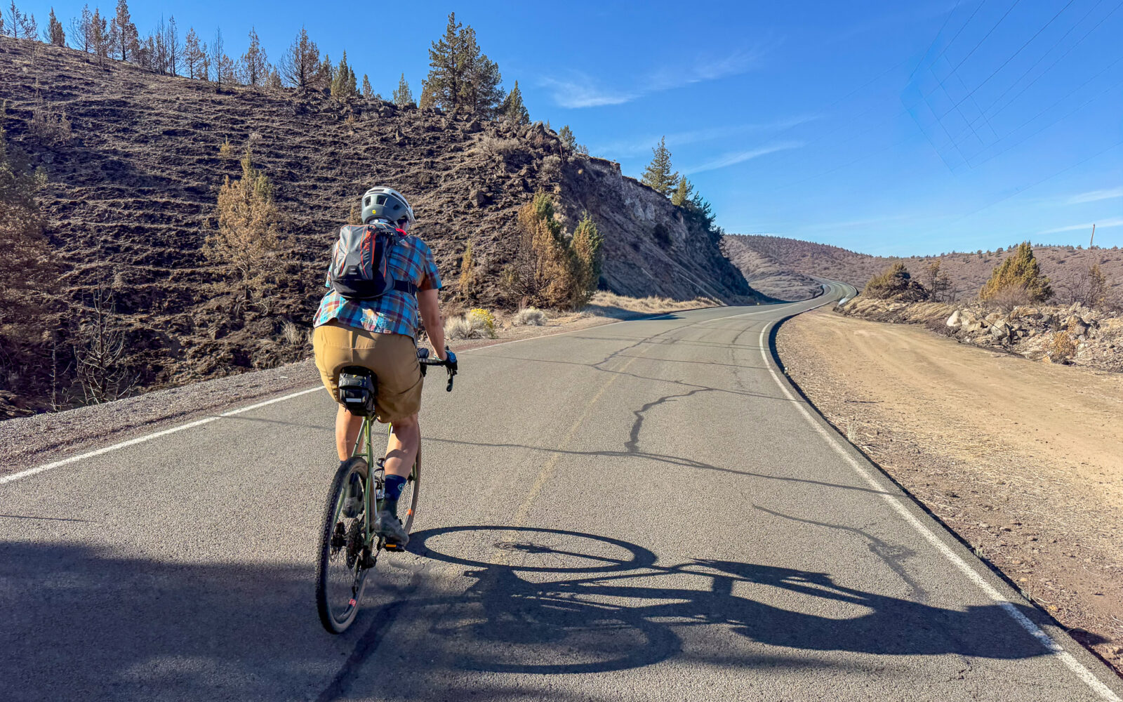 Cyclist on road approaching Lake Simtustus.