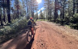 Red cinder road with cyclist.