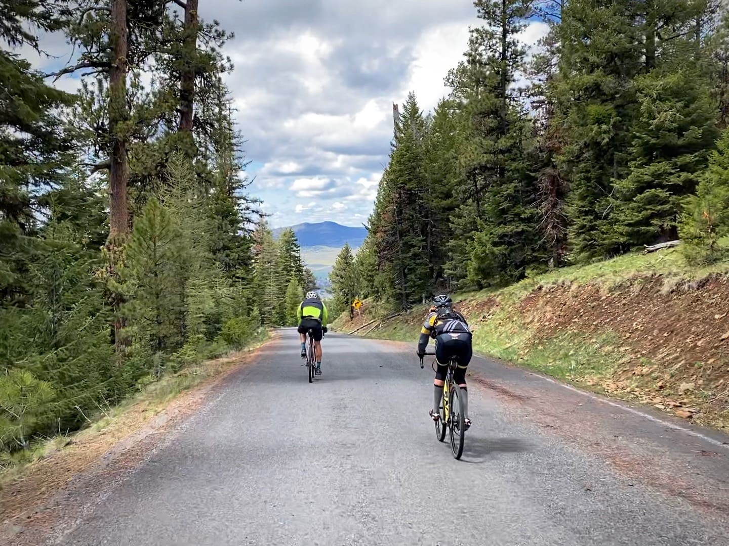 Two cyclists descending NF-12 in the Ochoco Mountains.