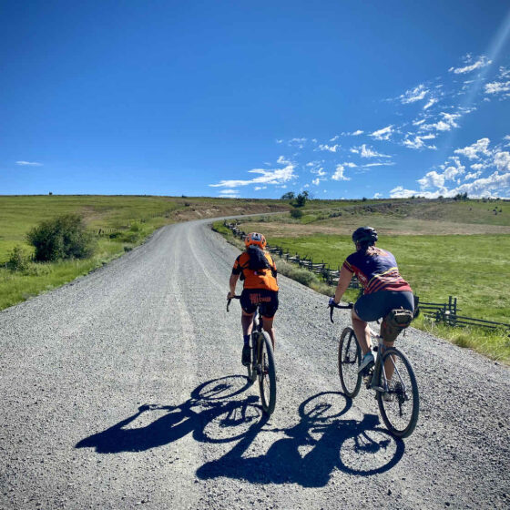 couple cycling on gravel road together