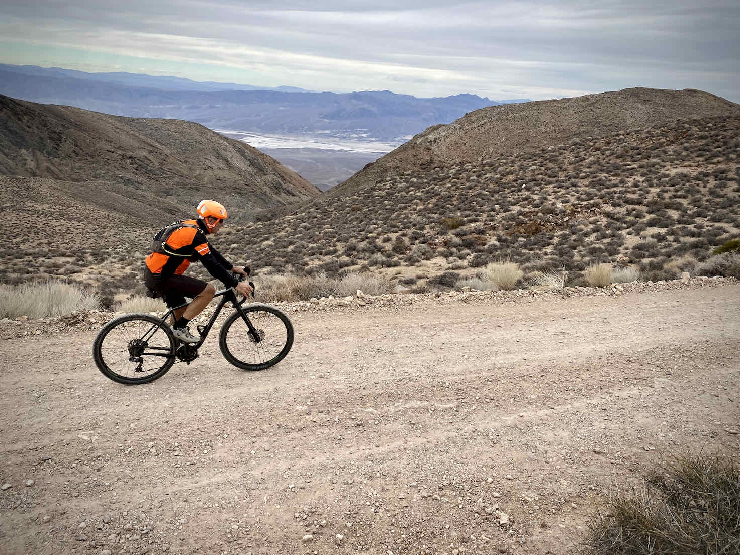 Gravel cyclist with the Death Valley basins in the background.