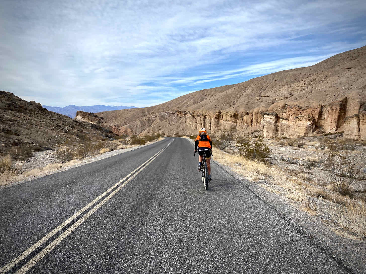Cyclist on paved road in Death Valley.