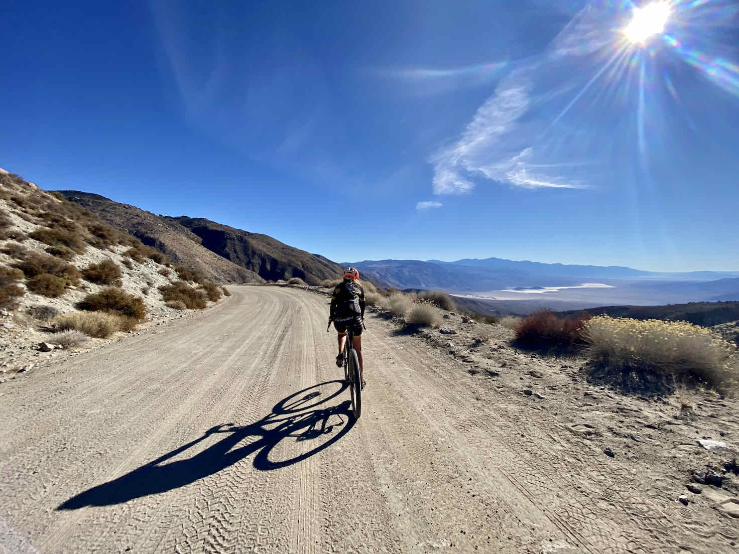 Cyclist on dirt road overlooking Panamint Valley in Death Valley.