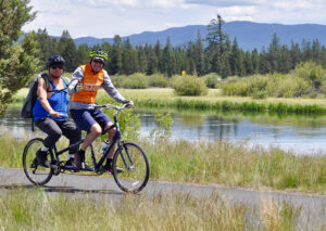 Adaptive athlete on bike near Deschutes River.