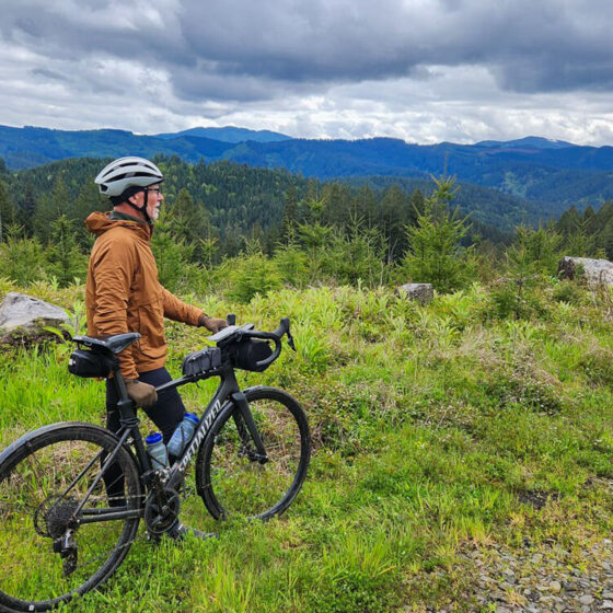 Person looking into distance with bike.