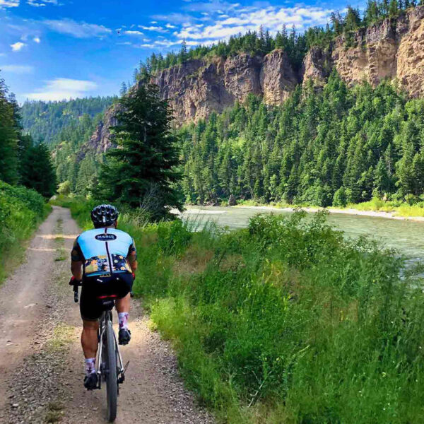 Gravel cyclist along river.