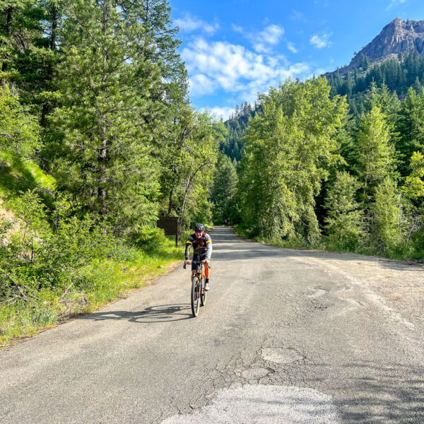 Gravel cyclist riding rough paved road in Washington state.