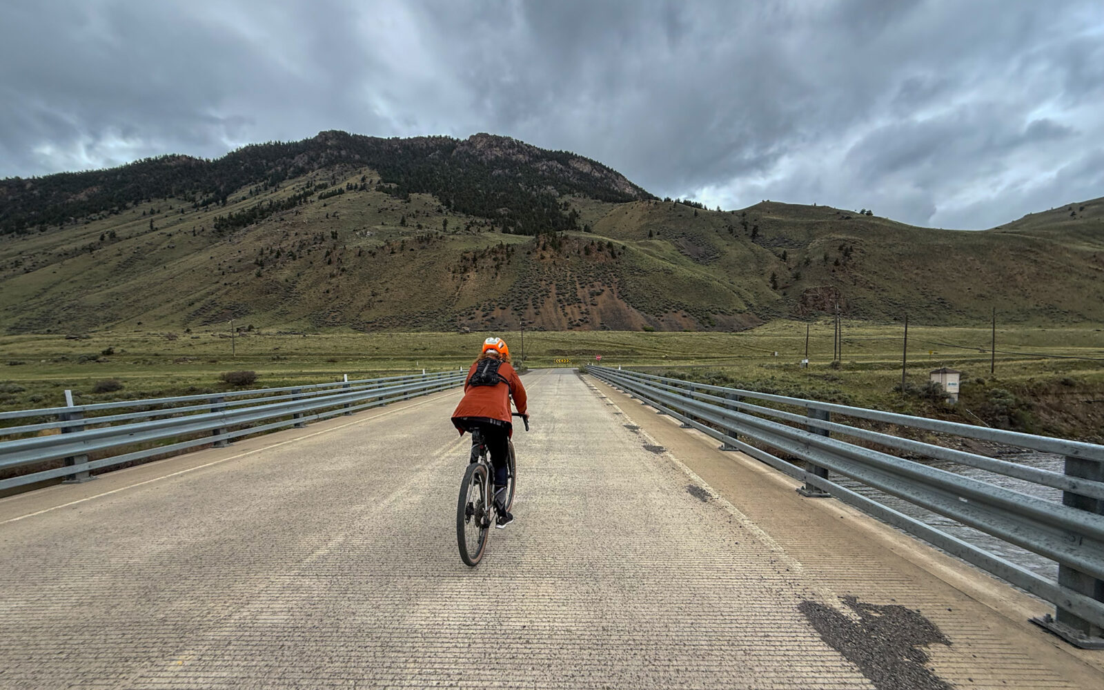 Cyclist crossing bridge